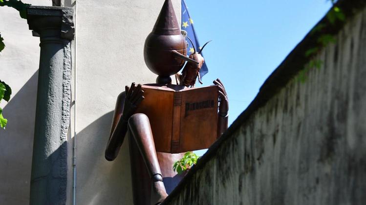 La scultura di Pinocchio con il grillo parlante vigila sulla biblioteca